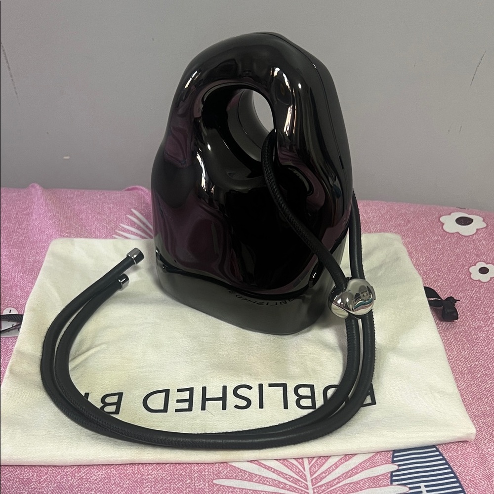 Published by chrome cross body bag!Glossy Black Sculptural Handbag